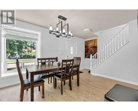 A dining room with a wooden table and chairs.