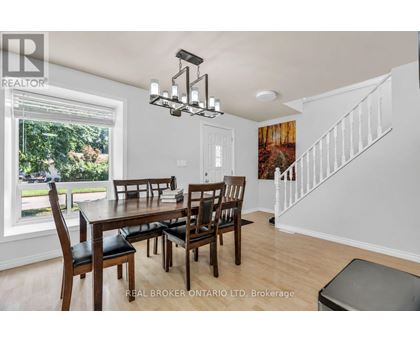 A dining room with a wooden table and chairs.