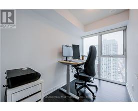 A room with a desk, chair, and printer.