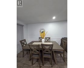 A dining room with a table set for four.