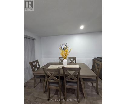A dining room with a table set for four.