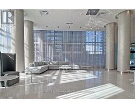 A modern living room with a large sectional sofa and a television.