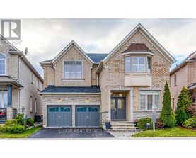 A two-story house with a garage is for sale.