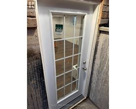 A white door with a glass panel and a handle.
