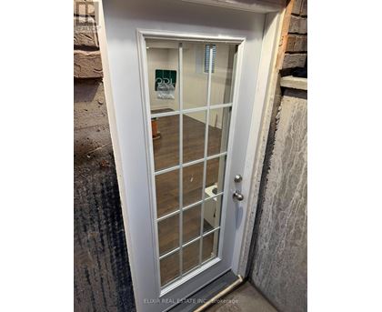 A white door with a glass panel and a handle.