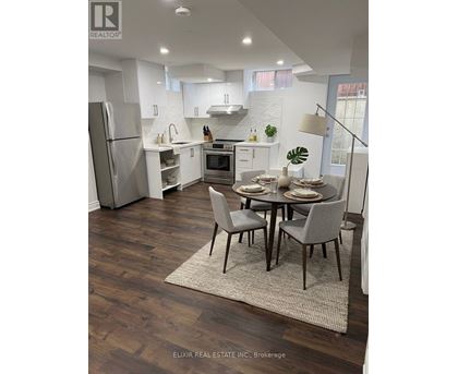 A modern kitchen with a dining table set for two.