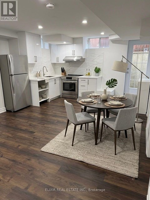 A modern kitchen with a dining table set for two.