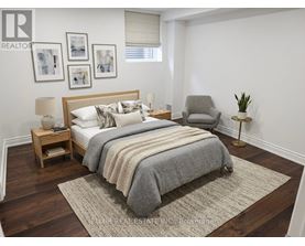 A bedroom with a large bed, a nightstand, a chair, and a rug.