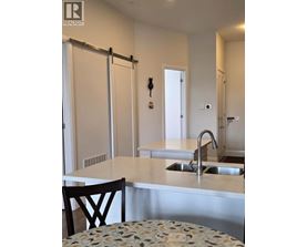 A kitchen with a sink and a chair.