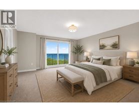 A bedroom with a large bed and a view of the ocean through the window.
