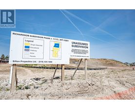 A sign for Richardson Subdivision Phase 3 shows a map of the area with single detached homes, educational walkways, and row homes.