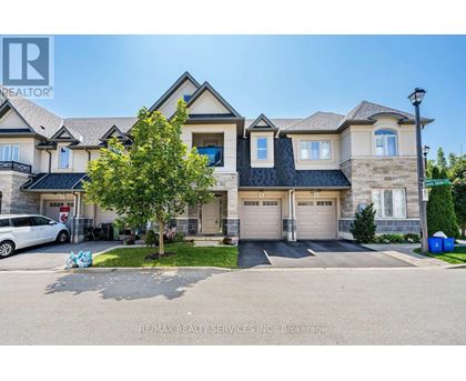 A large house with a car parked in front.