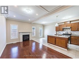 A spacious living room with hardwood floors and a fireplace.