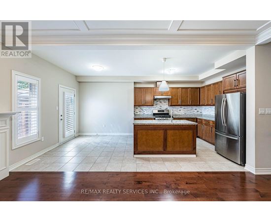 A kitchen with wooden cabinets and a refrigerator.