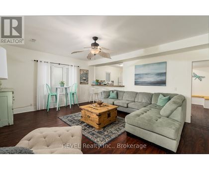 A living room with a grey couch and a wooden coffee table.