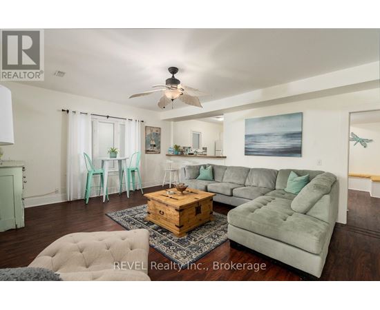 A living room with a grey couch and a wooden coffee table.