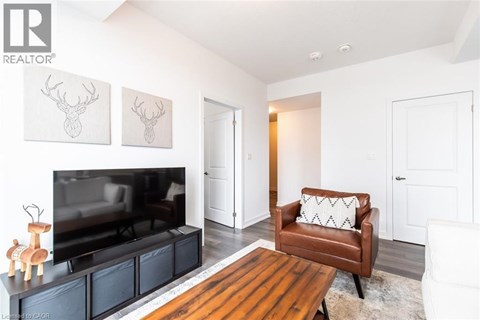 A living room with a brown leather chair and a television.