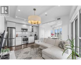 A modern kitchen with a white color scheme and a dining area with a white couch.