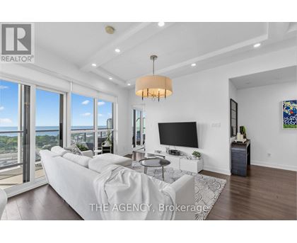 A modern living room with a large window overlooking the ocean.