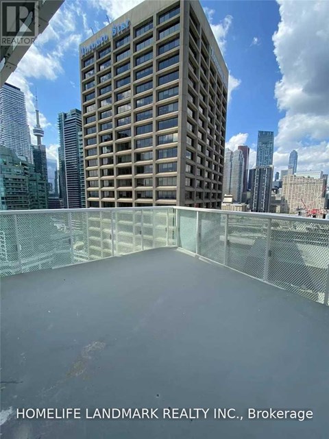 A balcony with a railing and a building in the background.