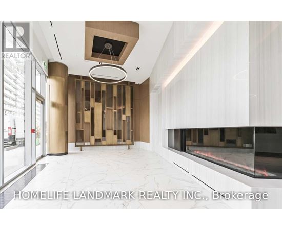A modern interior space with a glass wall and a fireplace.