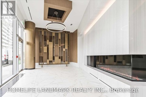 A modern interior space with a glass wall and a fireplace.