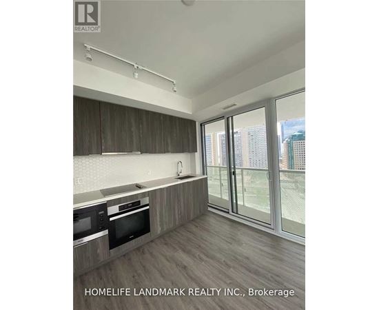 A kitchen with wooden cabinets and a microwave.