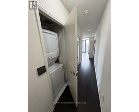 A white washer and dryer are in a small alcove.
