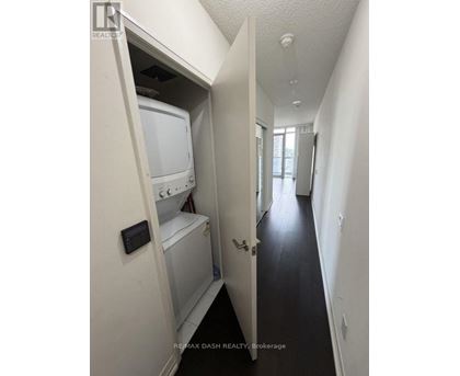 A white washer and dryer are in a small alcove.