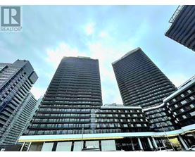 Three tall buildings are seen from a low angle.