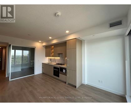 A kitchen with a stove top oven and a refrigerator.