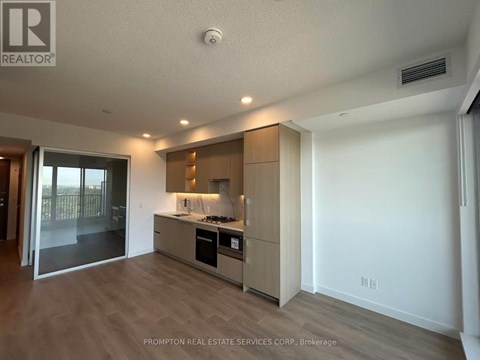 A kitchen with a stove top oven and a refrigerator.