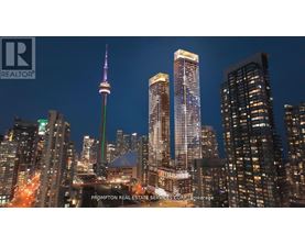 A cityscape at night with the CN Tower prominently displayed.