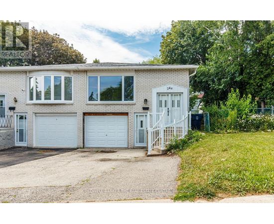 A two-story house with a white garage door and a white door.
