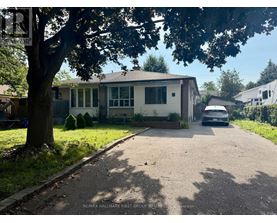 A residential house with a car parked in front.