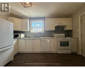A kitchen with white appliances and cabinets.