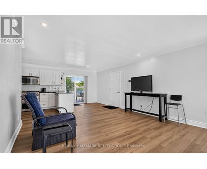 A spacious living room with a television and a chair.