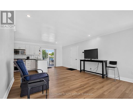 A spacious living room with a television and a chair.