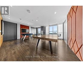 A modern dining room with a wooden table and chairs.