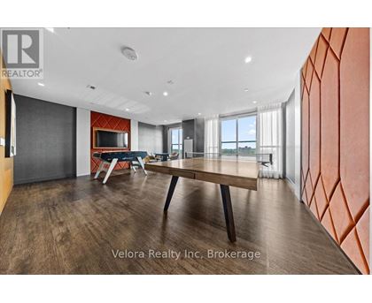A modern dining room with a wooden table and chairs.