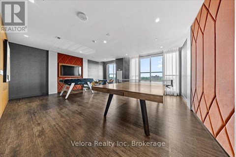 A modern dining room with a wooden table and chairs.