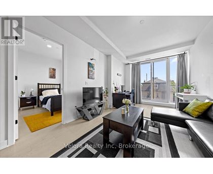 A bedroom with a bed, a couch, and a coffee table.