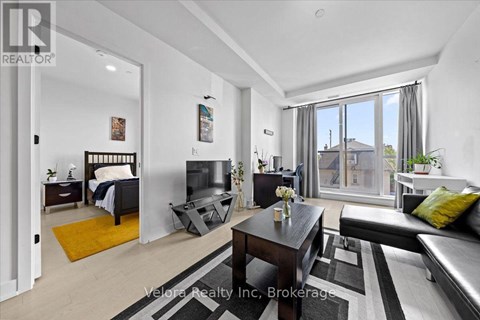 A bedroom with a bed, a couch, and a coffee table.