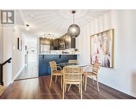 A dining room with a table set for four.