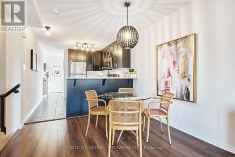 A dining room with a table set for four.
