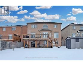A real estate photo of a house with a snowy front yard.