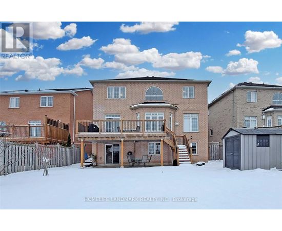 A real estate photo of a house with a snowy front yard.
