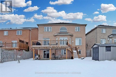 A real estate photo of a house with a snowy front yard.