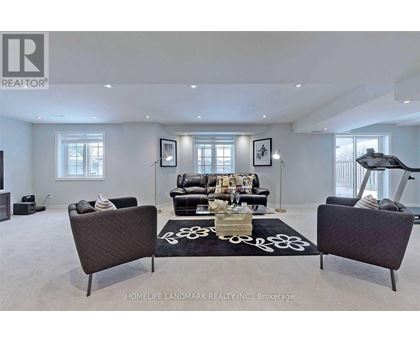 A living room with a black sofa and a coffee table.