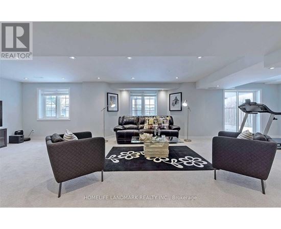 A living room with a black sofa and a coffee table.
